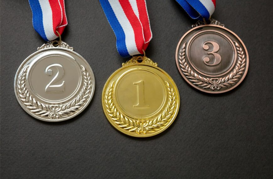 Gold, silver and bronze medals set on black background. Sports athletes winners prize