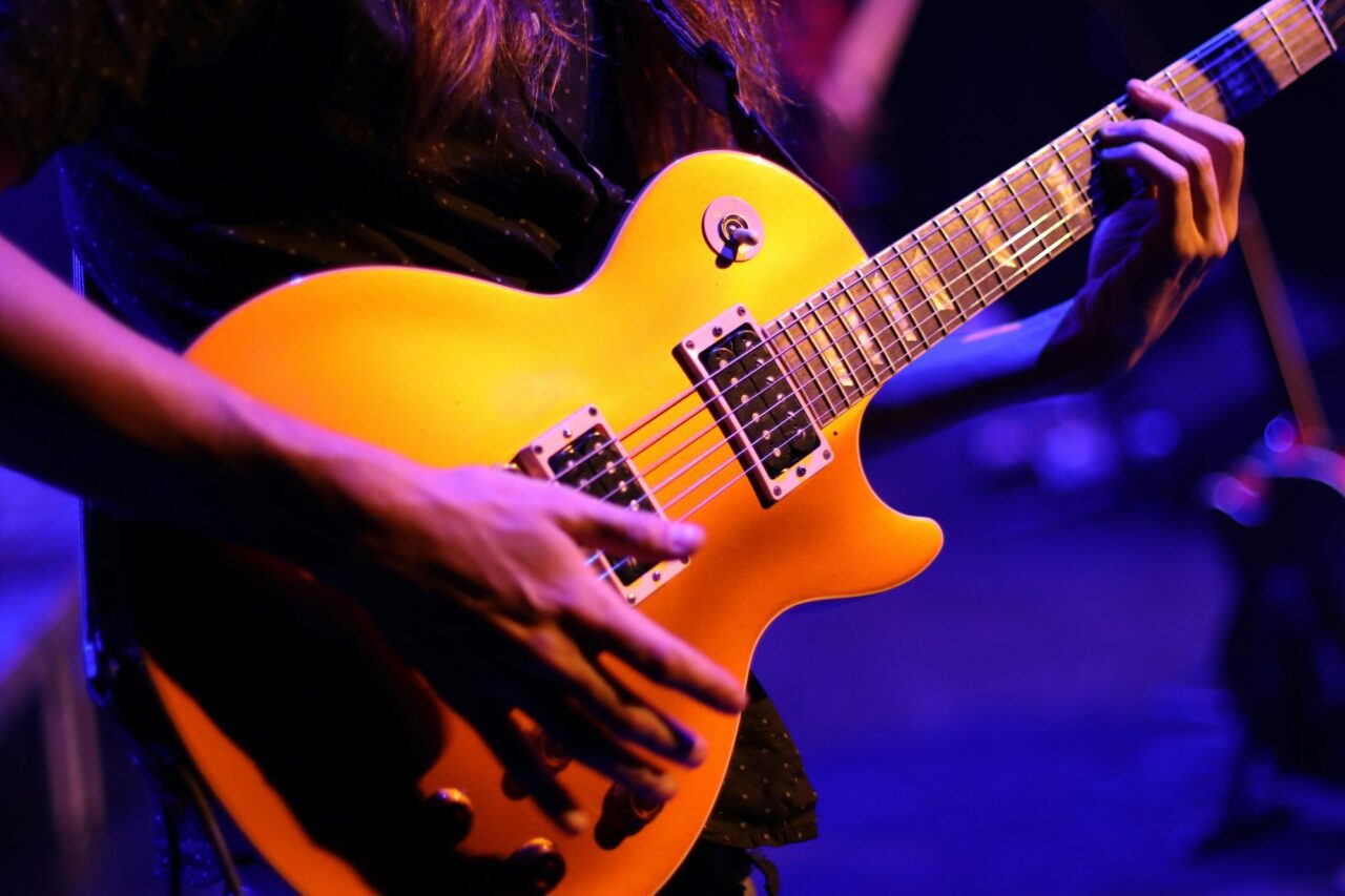 man playing guitar on the stage