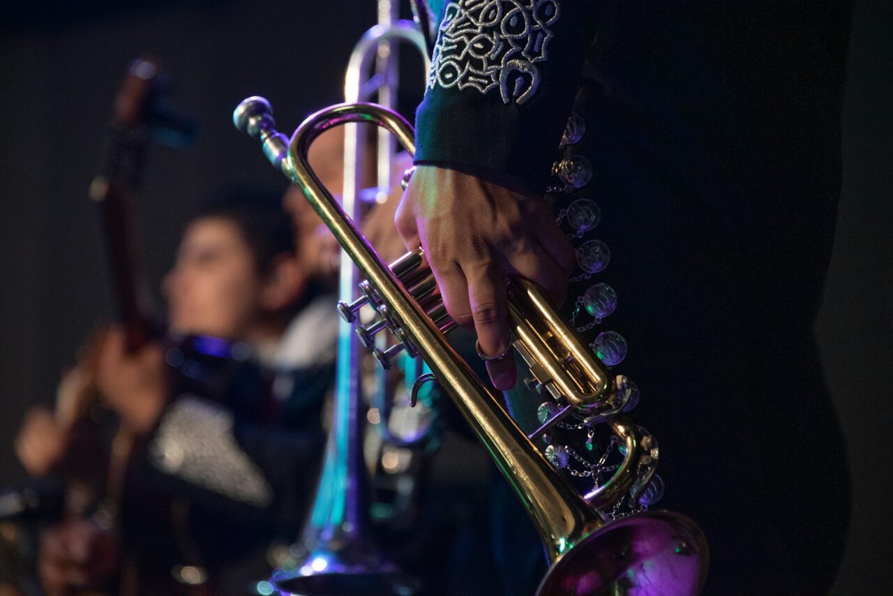 MEXICAN MUSICIAN MARIACHI WITH TRADITIONAL TRUMPET IN MEXICAN SERENATA