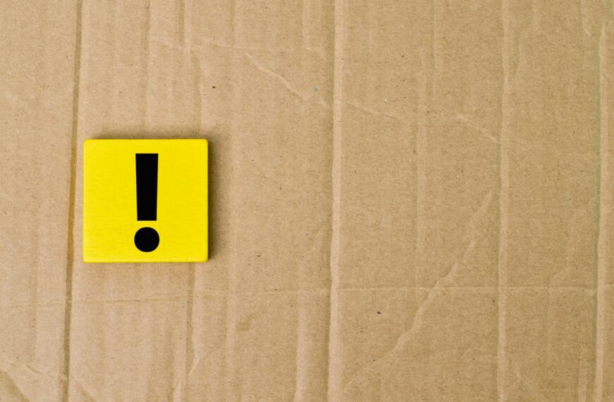 Exclamation mark drawn on wooden board over cork background with copy space.