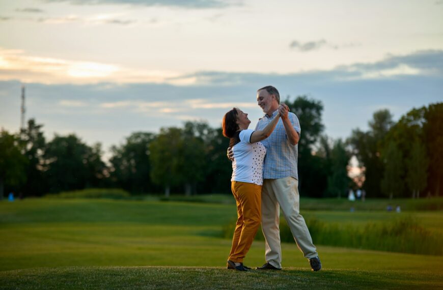 Happy couple dancing outdoors.