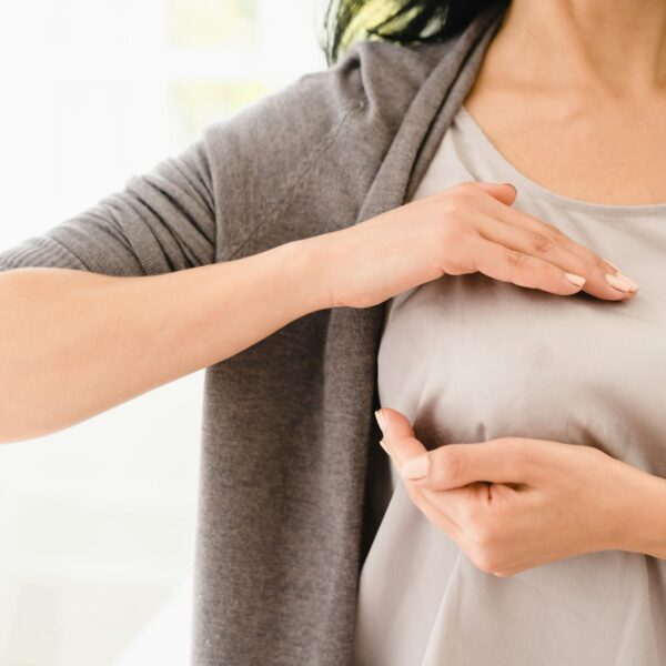 Palpation of her breast for prevention breast cancer. Self-checking medicine. World cancer day