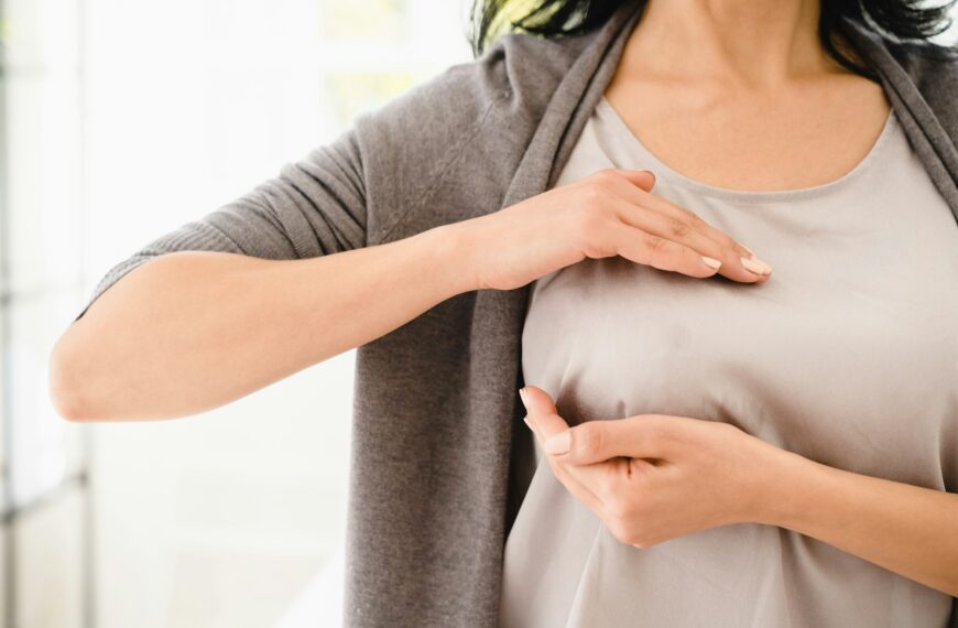 Palpation of her breast for prevention breast cancer. Self-checking medicine. World cancer day