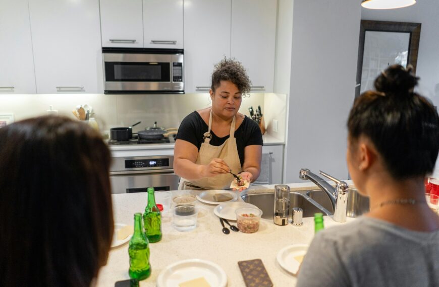 Young woman teaching a dumpling cooking class with friends.