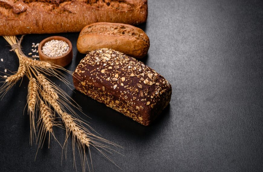 Fresh Bread on black background, top view, copy space