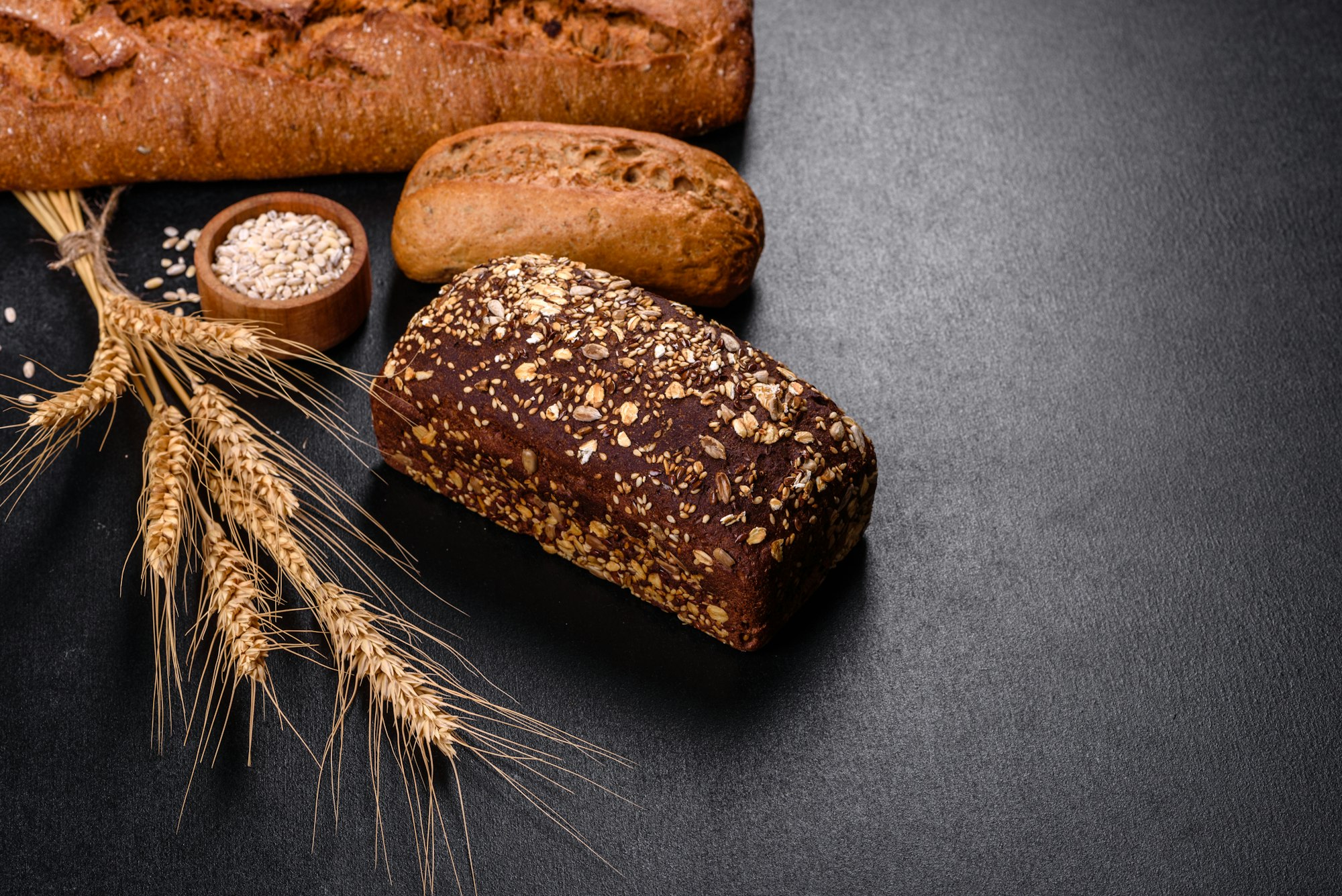 Fresh Bread on black background, top view, copy space