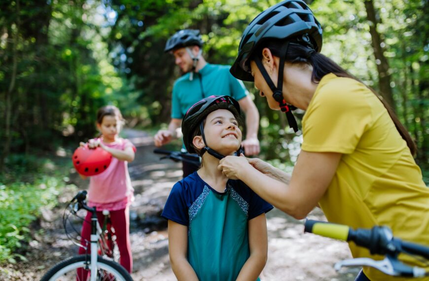 Young family with little children at bike trip together in nature.