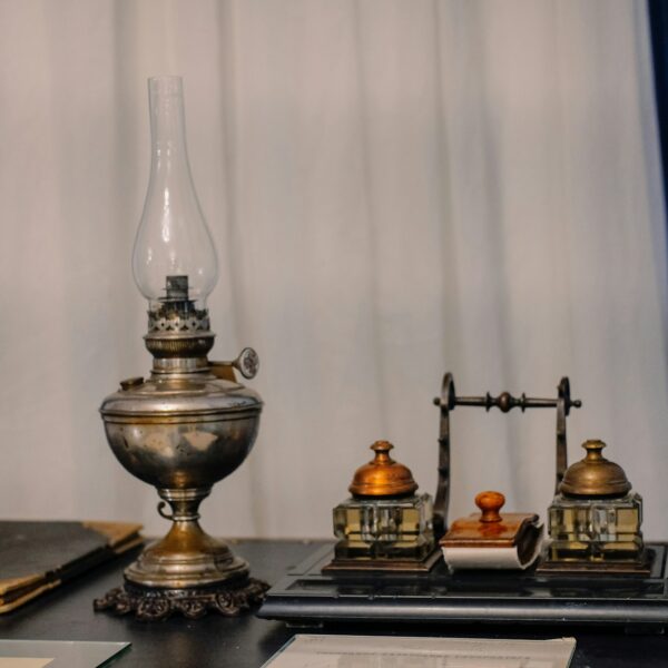 antique writer's desk with kerosene lamp and ink by the window