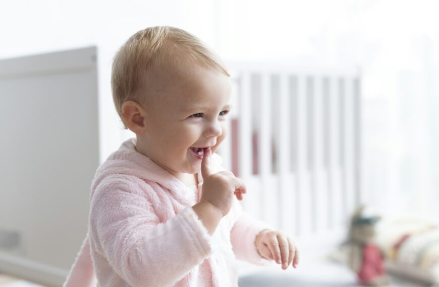 Cute baby girl smiling in her nursery
