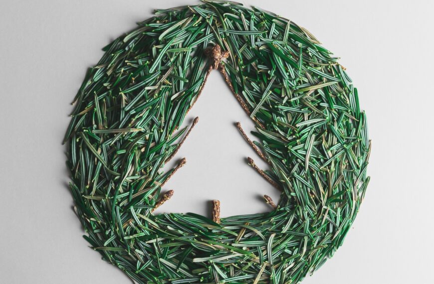 Christmas ball of Christmas tree needles on a gray background. Creative Christmas composition.