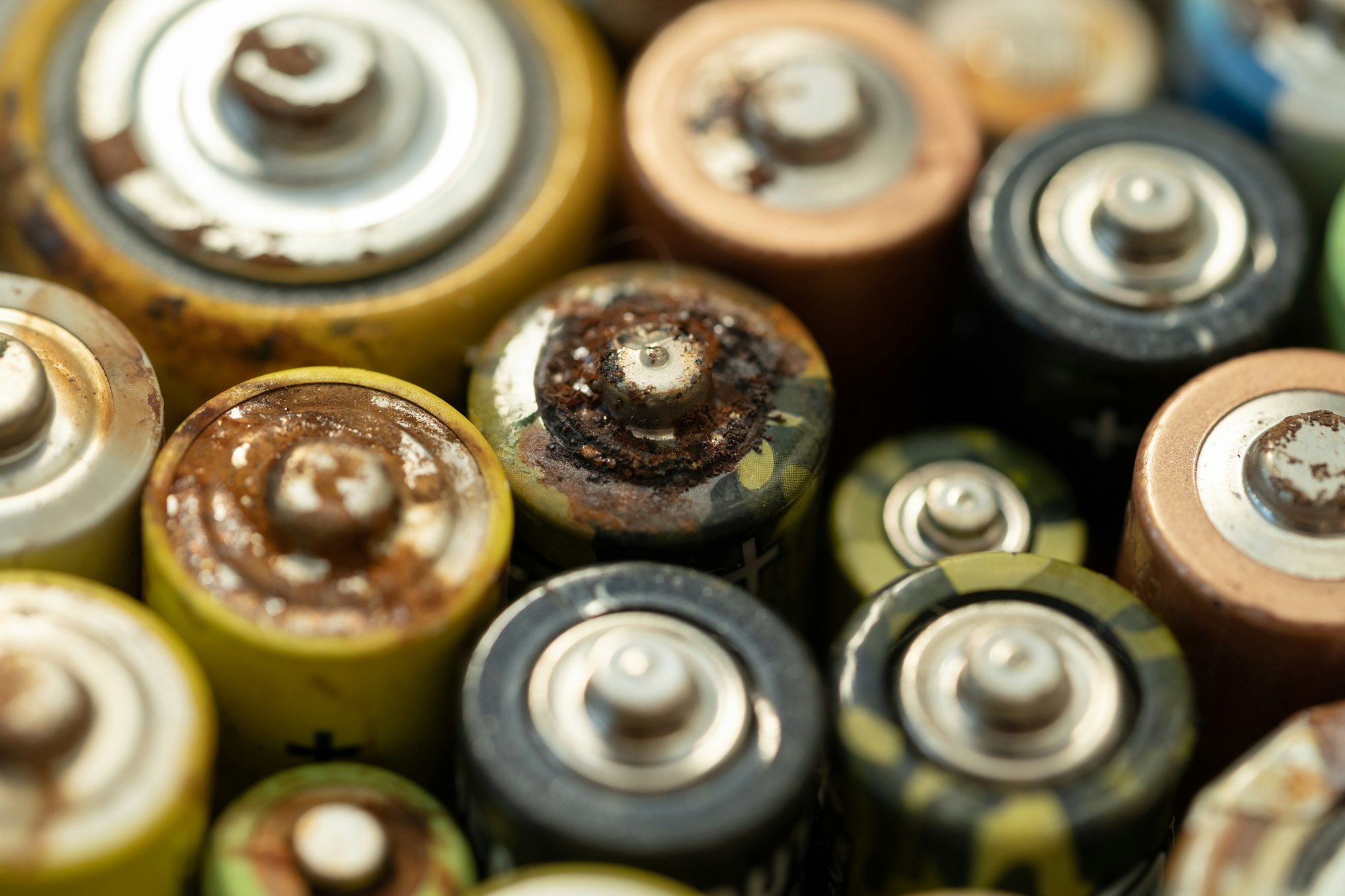 Closeup of used battery with traces of rust and corrosion. Electronic hazardous waste concept