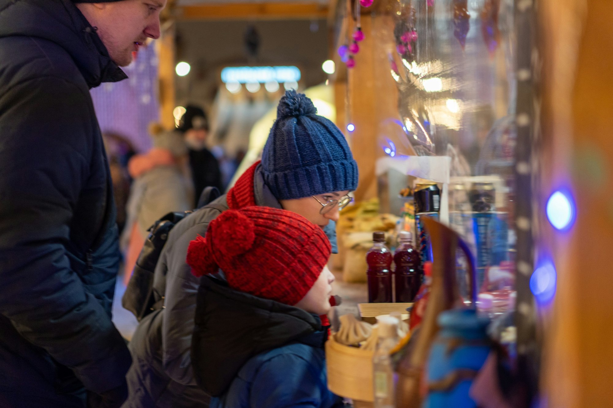 Family buying food at kiosk on Christmas market