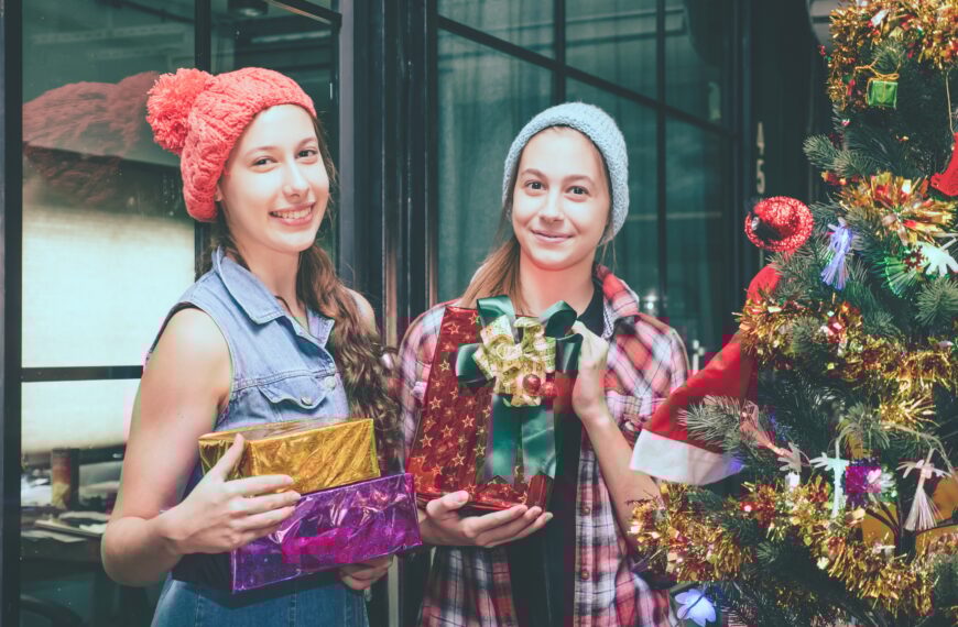 Beautiful girls with presents at Christmas party.