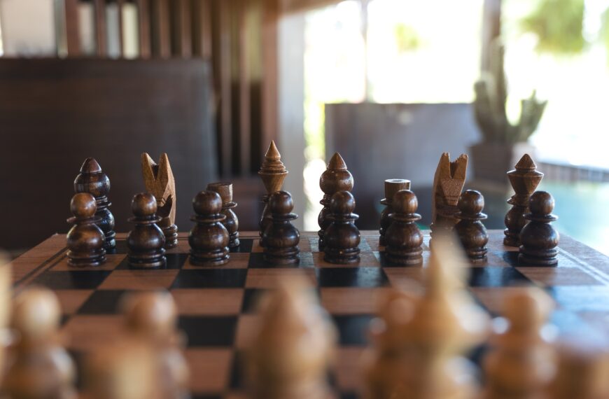 Closeup image of a wooden chess set on chessboard