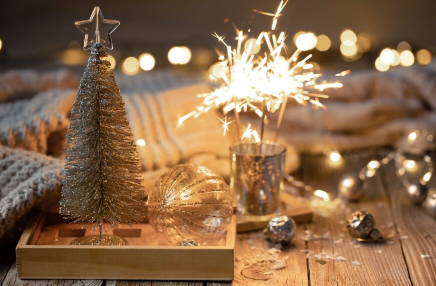 Cozy Christmas background with glowing sparklers and decor details.