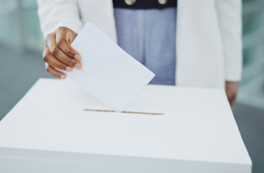 Hand, ballot and box for vote paper at president election cast, poll station choice or government s