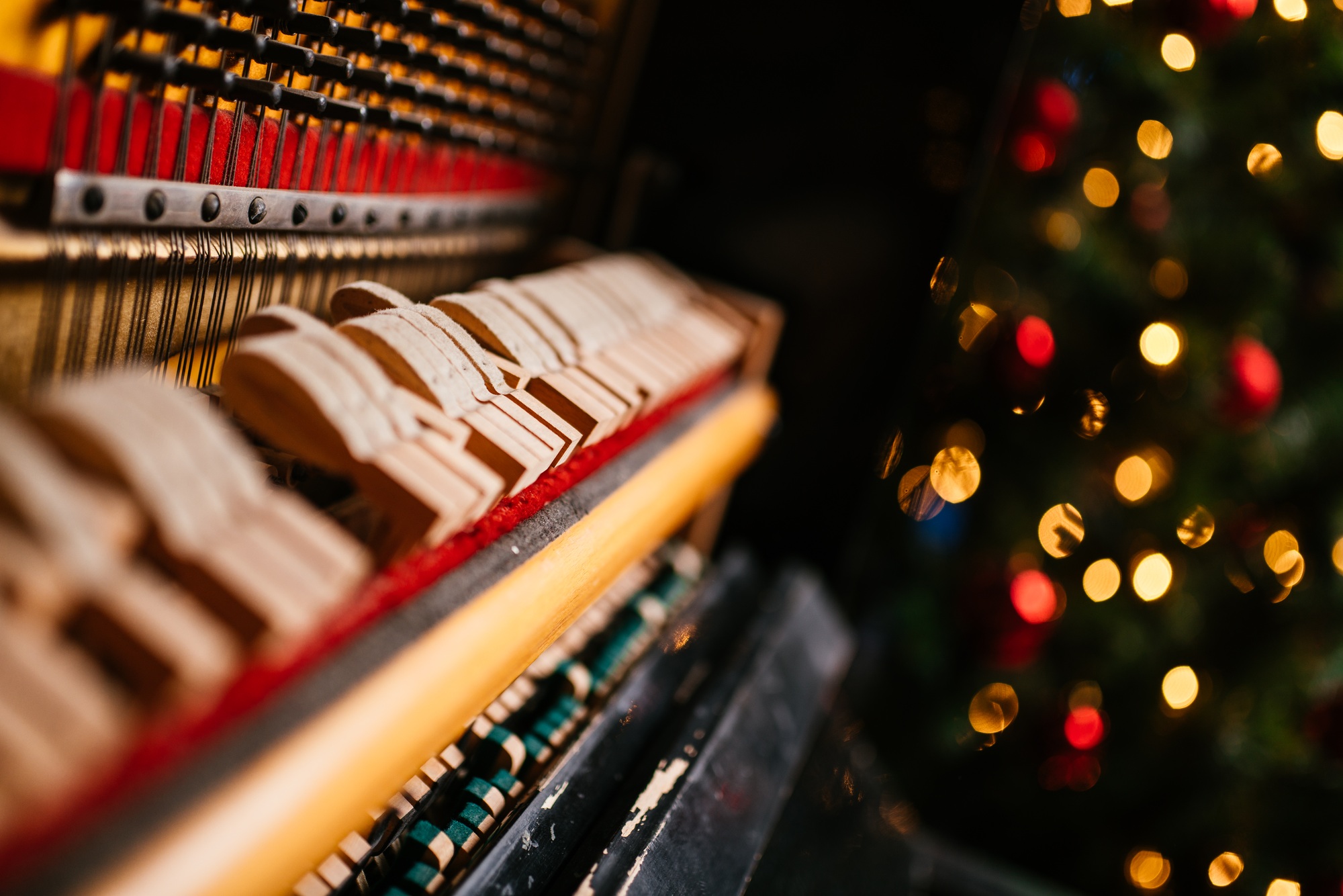 Piano keyboard with Christmas decoration, closeup