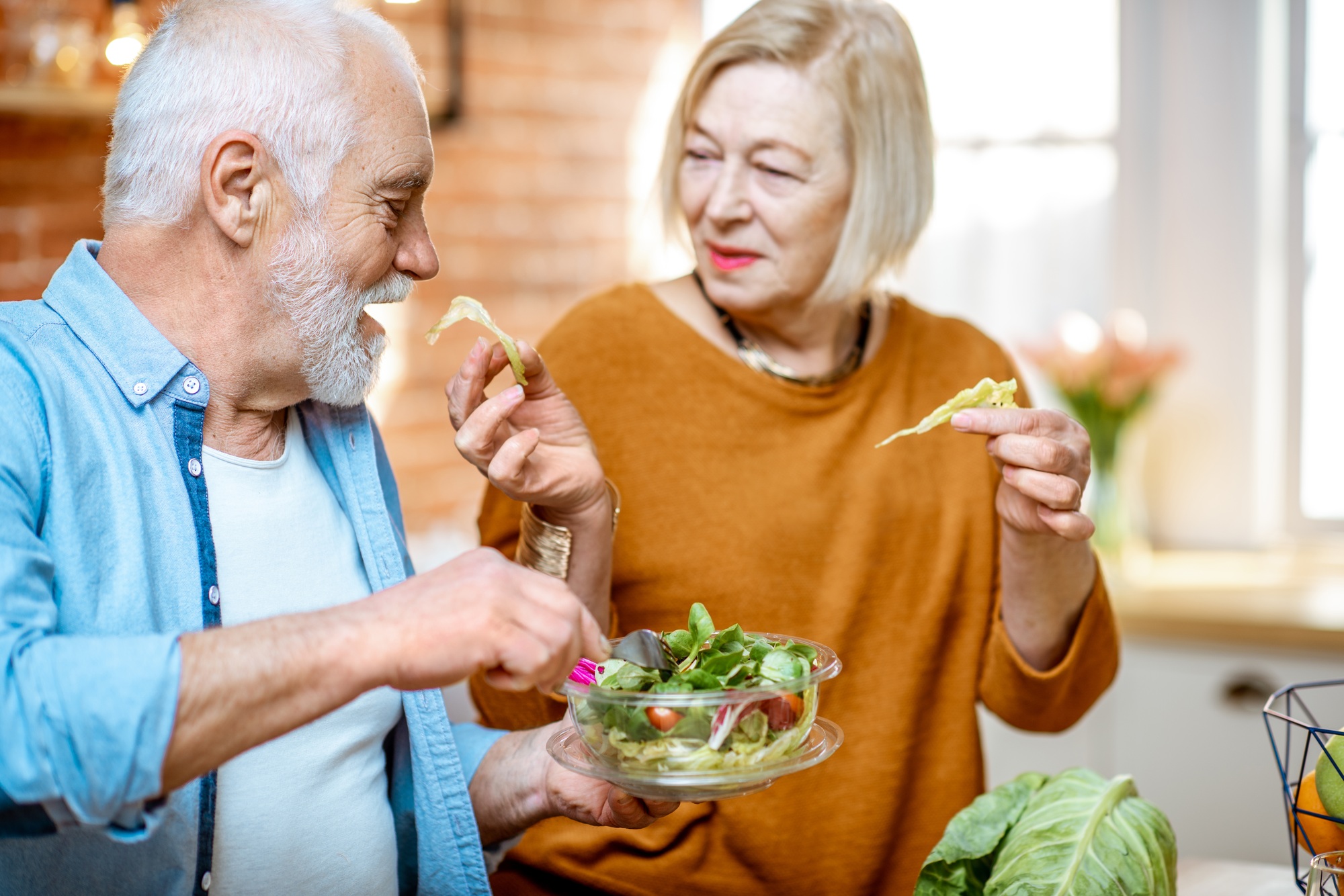 Senior couple with healthy food at home