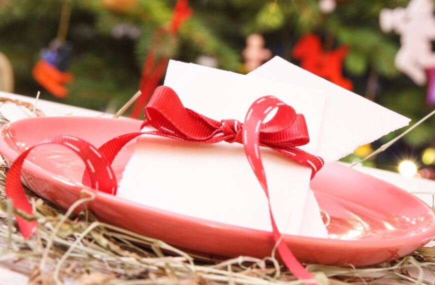 Traditional polish christmas eve wafer with ribbon and christmas tree with lights and decoration