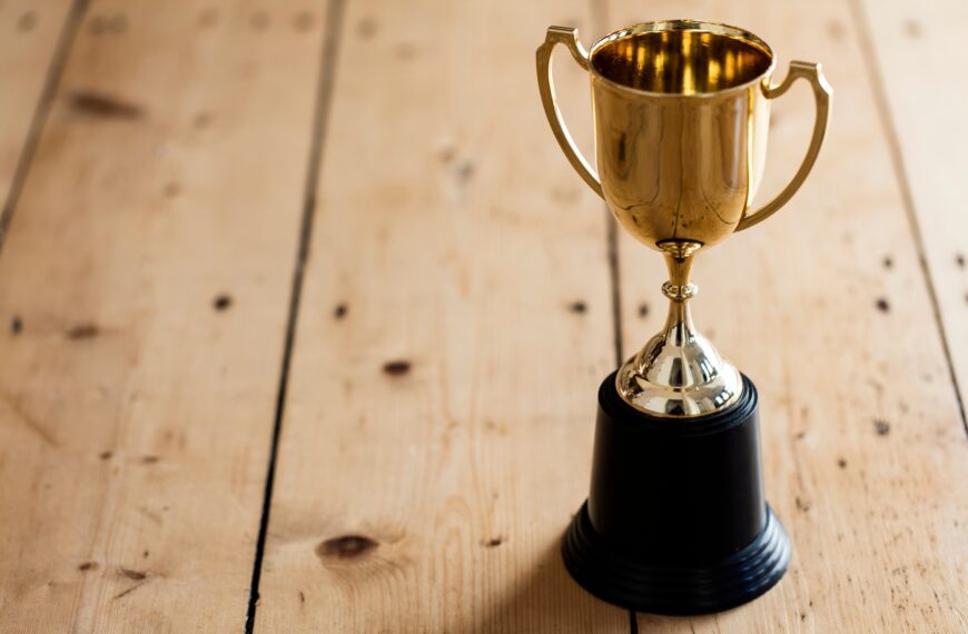 Gold winners trophy on a wooden background