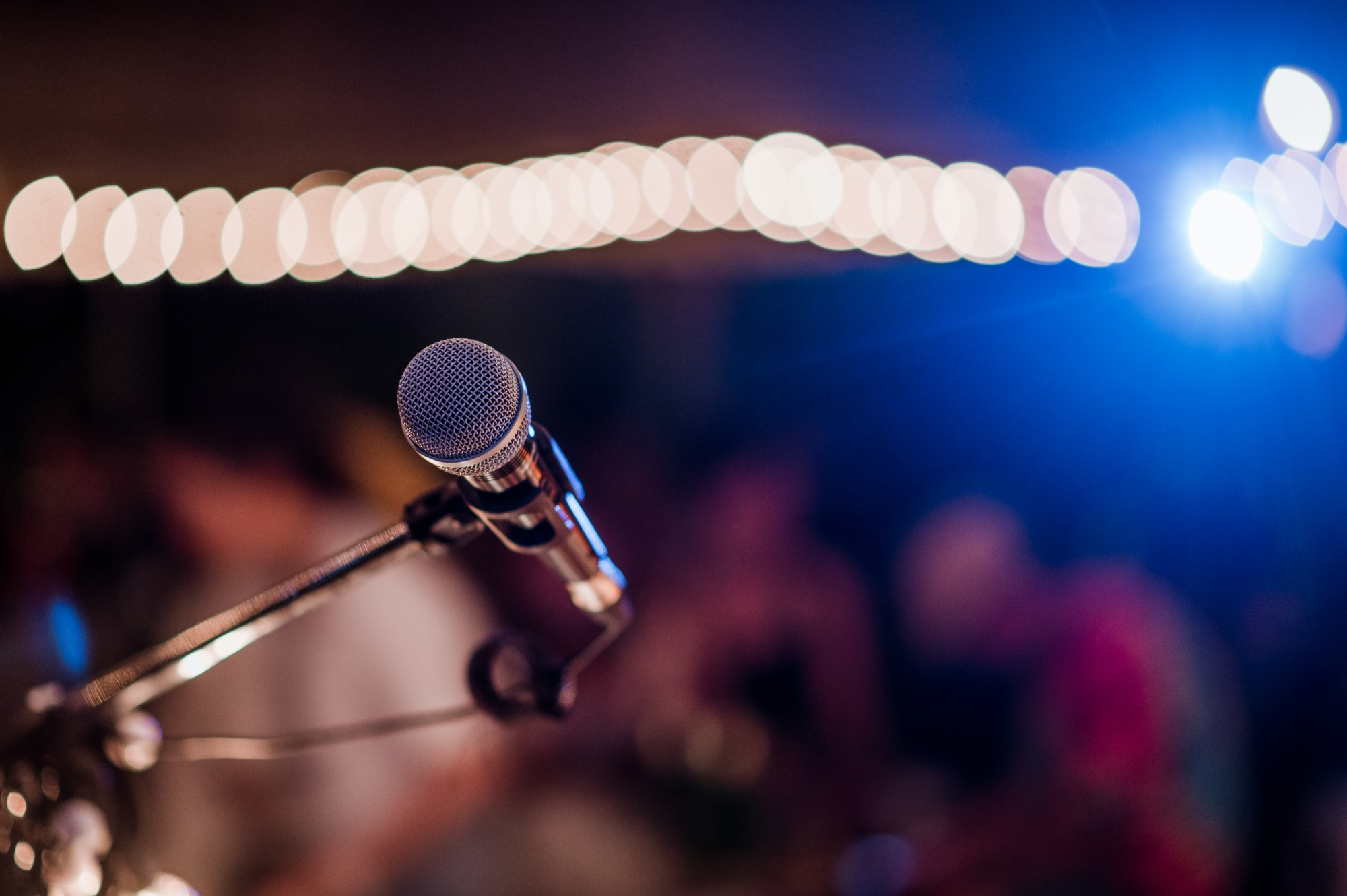 Microphone head on stage in a dark room. Concert,mini concert and music festivals.