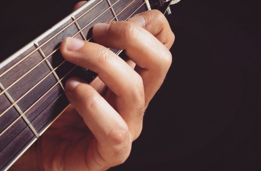 Playing guitar - fingers playing guitar closeup