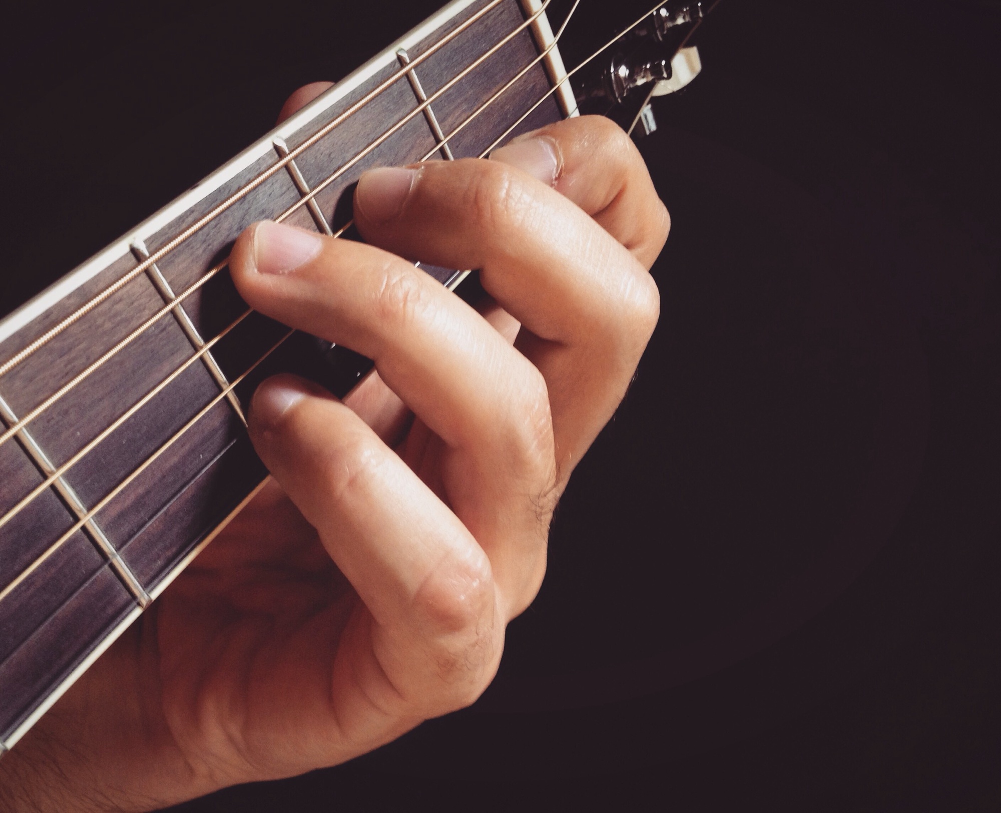 Playing guitar - fingers playing guitar closeup