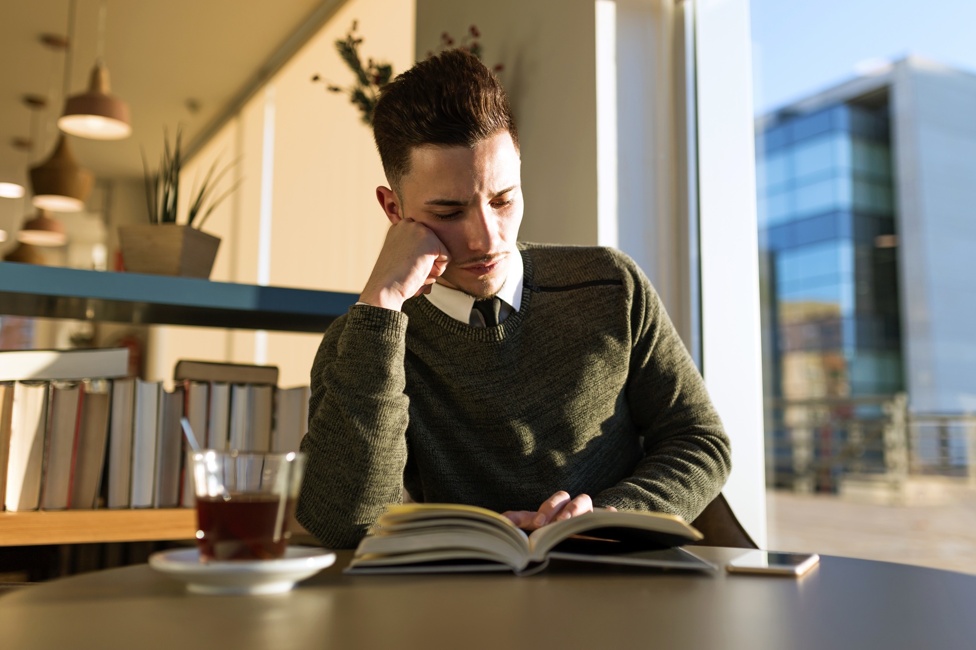 Pensive man reading a book