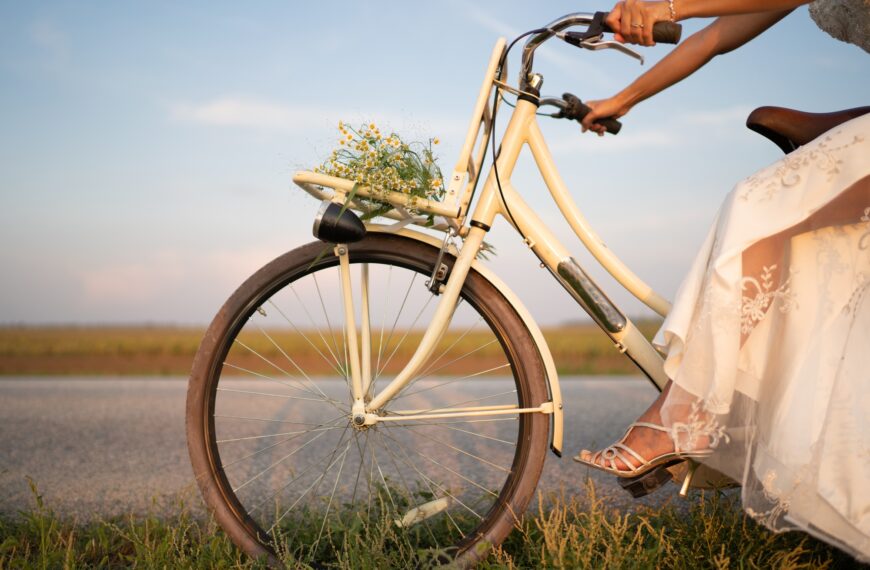 The bride is riding a bicycle